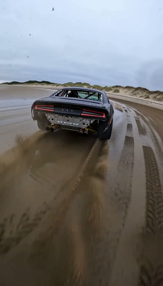 Still from the film: Camera bolted to the muscle coupe. The beach